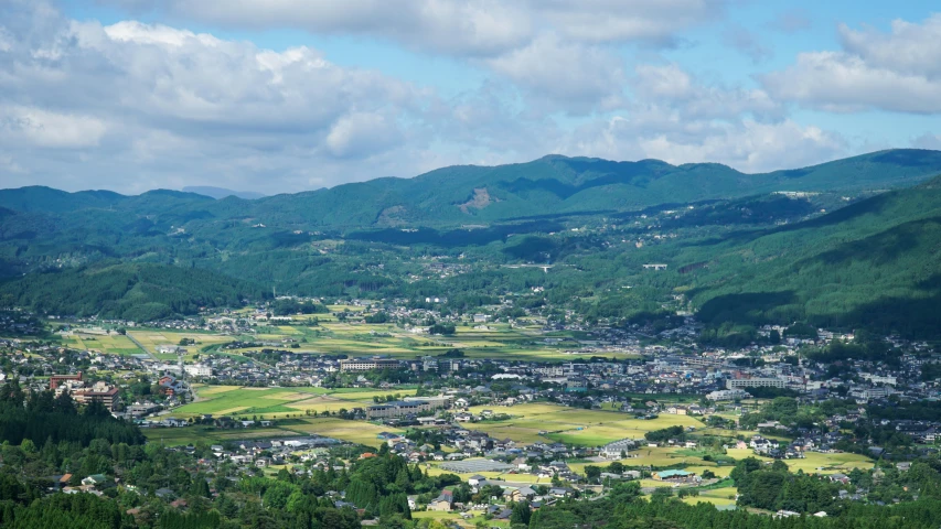 green mountains surround a small town in the middle