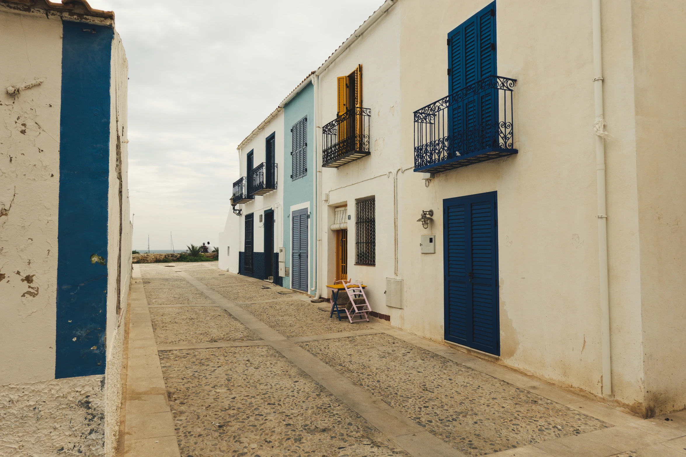 a row of colorfully painted buildings on an empty street