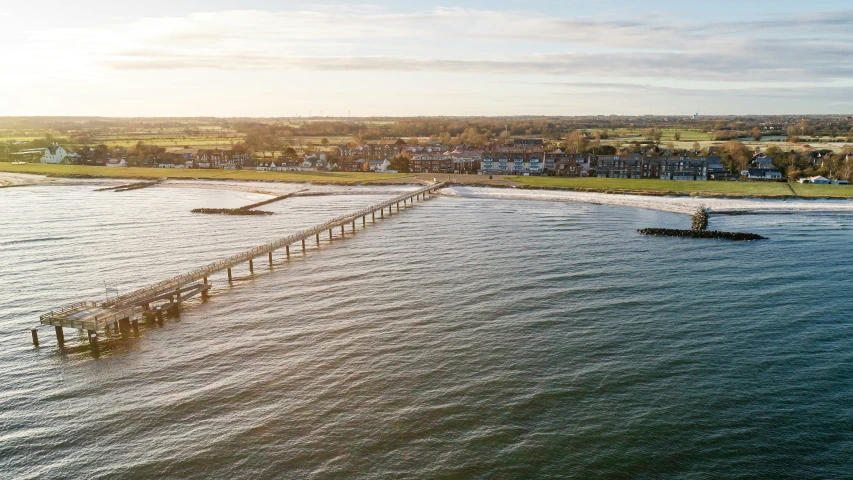 an aerial s of the water with a pier on it