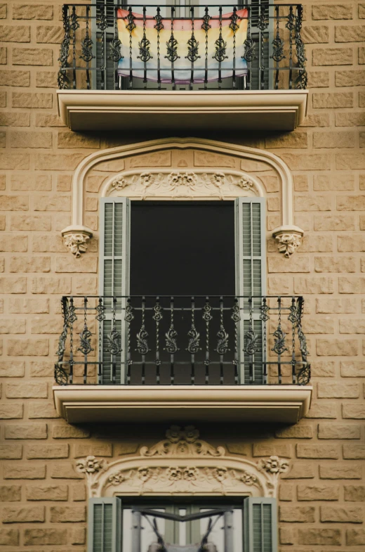 a brick building with a balcony over looking another building