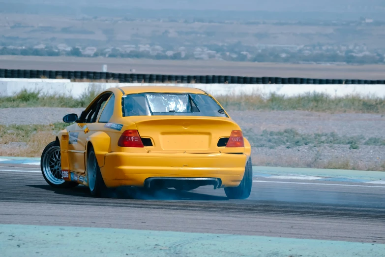 a yellow sports car with two wheels and exhaust