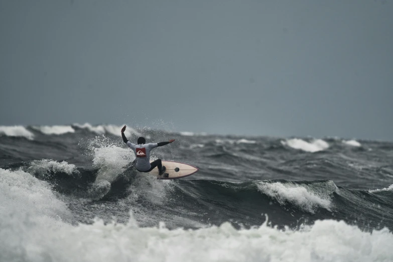 a person on a surfboard riding on some waves