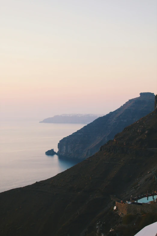 an overlook with a lone boat floating in the water