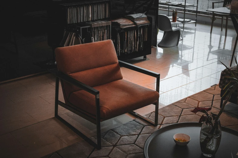 there is a room with a bookcase and an orange chair