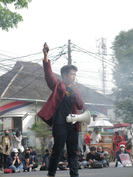 a man is playing music while people sit in the background