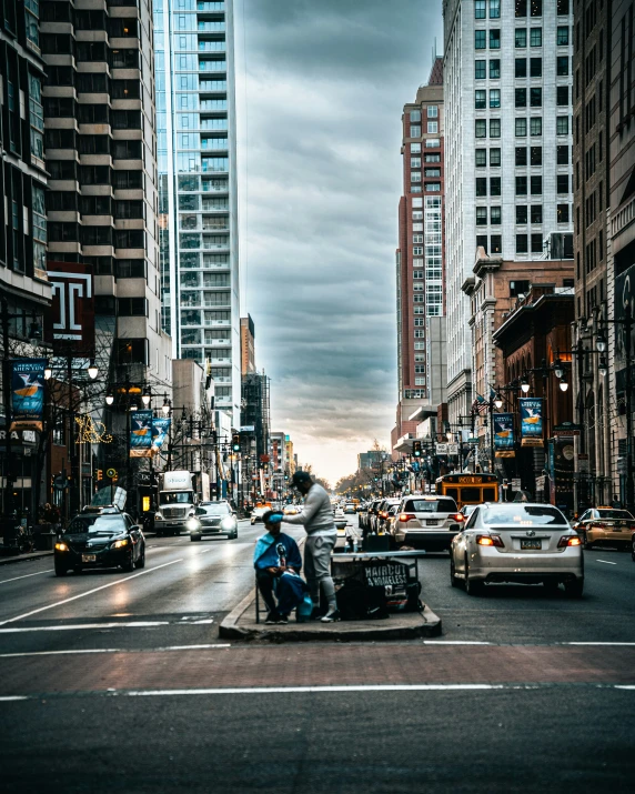 some traffic on a street by many buildings