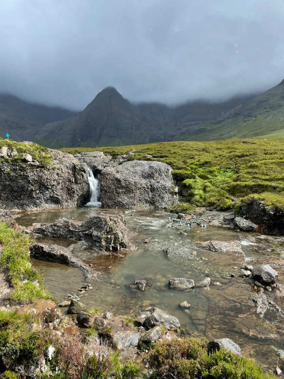 there is a mountain with a waterfall in it