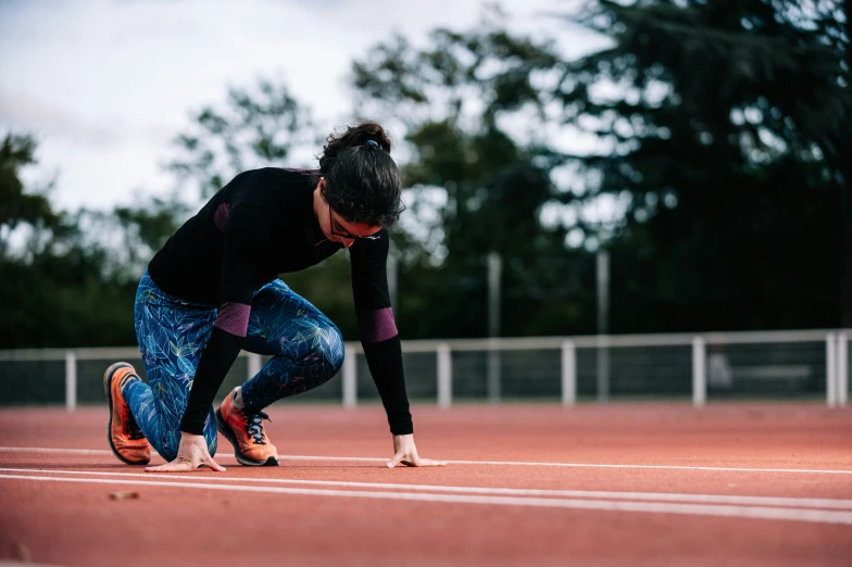 a woman bending over on a tennis court