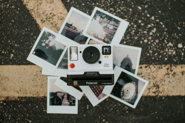 the polaroid is laying near many pos