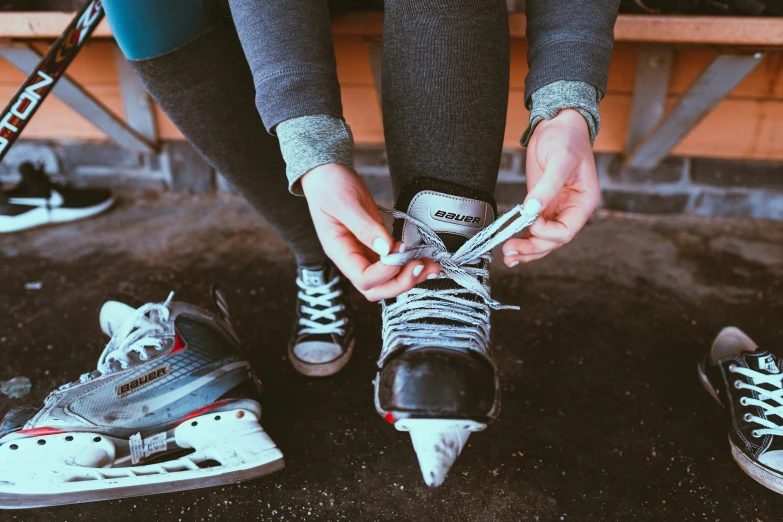 a person tying some type of shoelaces