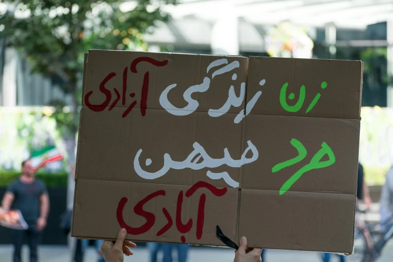 a man holding a cardboard sign that reads no one should give anything