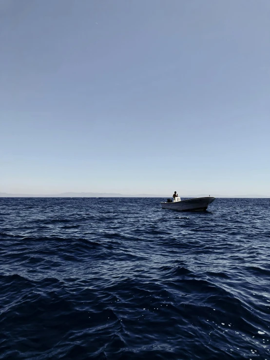 a small boat that is in the middle of the ocean