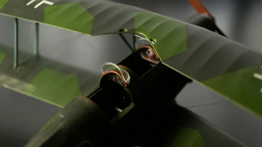 a small green machine is hooked up to a leaf