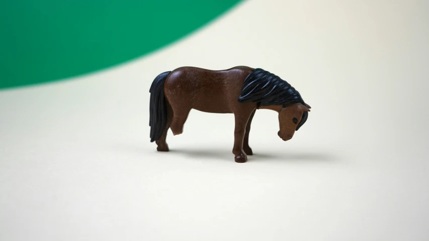 a small plastic horse is posed for a po