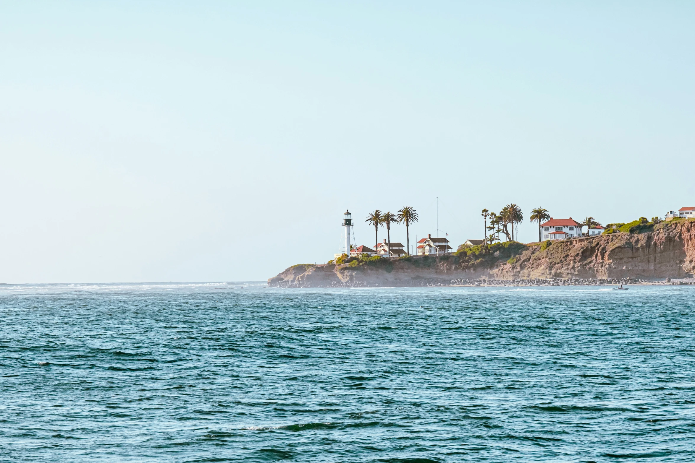 houses sitting on top of the island near the ocean