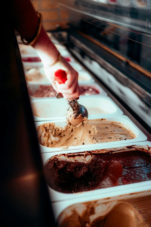 a close up of people scooping out some ice cream