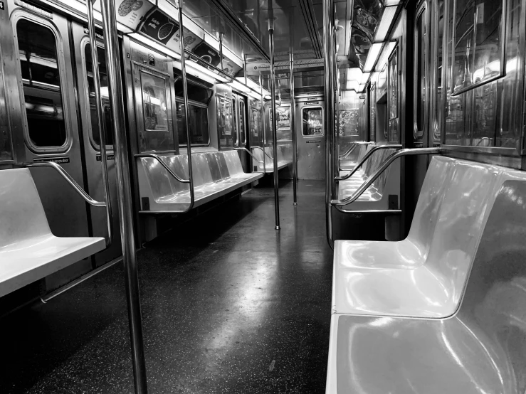 a subway car with several seats and no doors