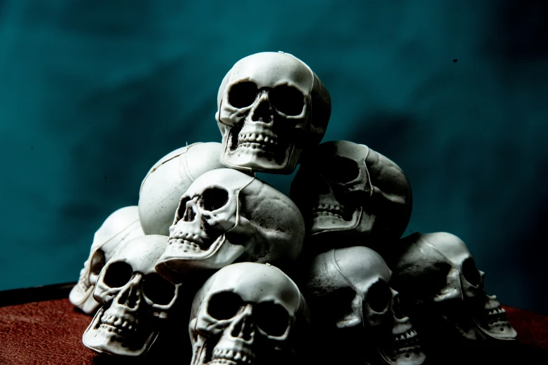 a bunch of fake skulls sit on top of a table
