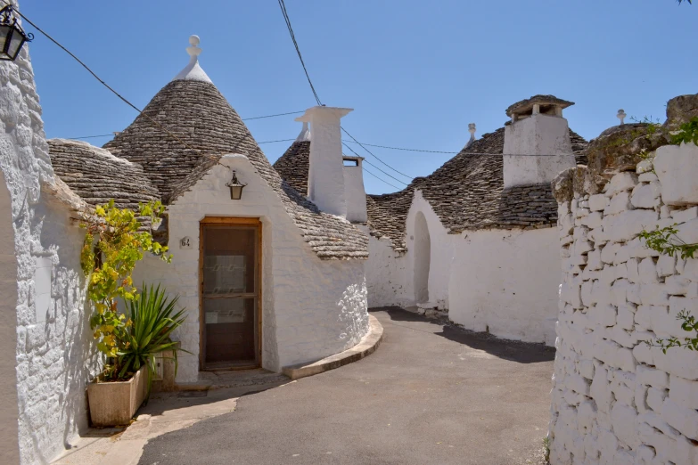 an empty street leads to whitewashed houses