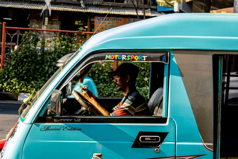 a person in a blue car on a street