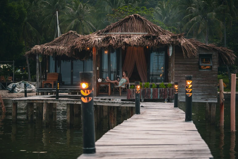 a dock with many torches and people sitting on chairs