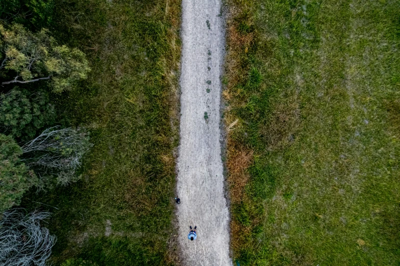 people walking in a straight line down a road