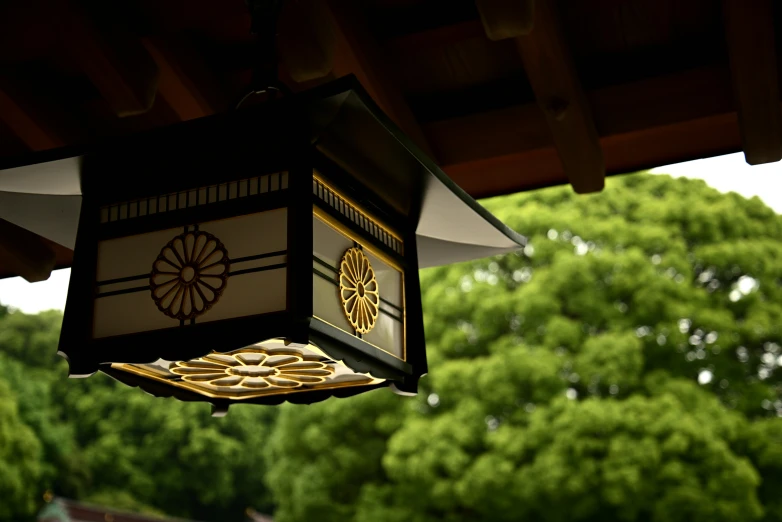 a lamp hanging over a wooden patio roof