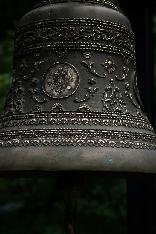 this is a large bell outside on a pole