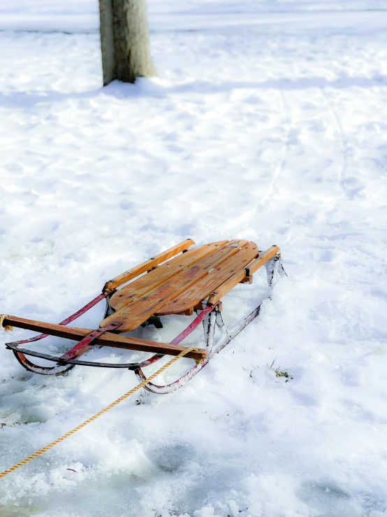 a sled is resting in the snow with no wheels