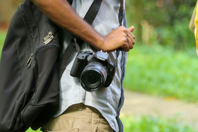 a man wearing a backpack with a camera in his back