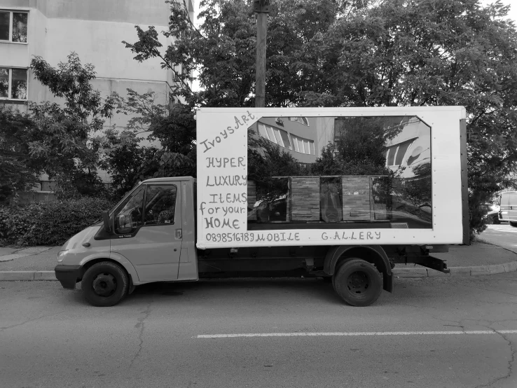 a truck with pictures on it parked in the street