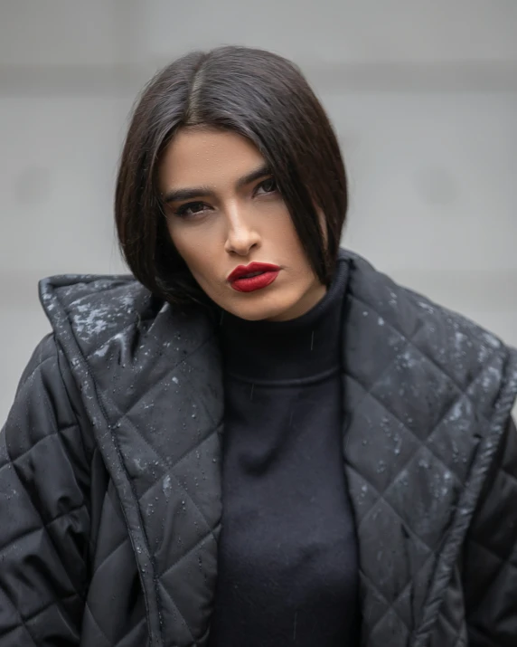 a woman with short hair and a red lipstick