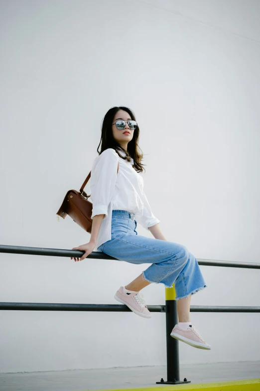 a woman on top of a pole in glasses