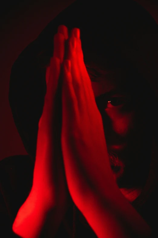 a young woman covers her face with hands