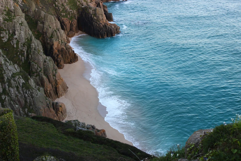 an ocean shoreline with cliff sides and the water