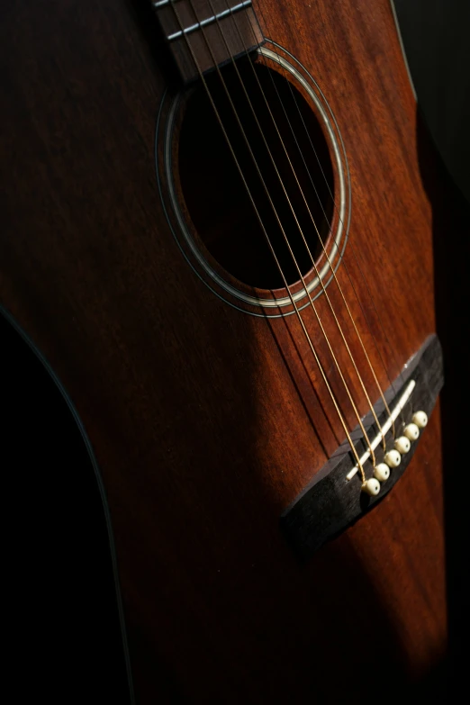 closeup of an acoustic guitar neck and strings