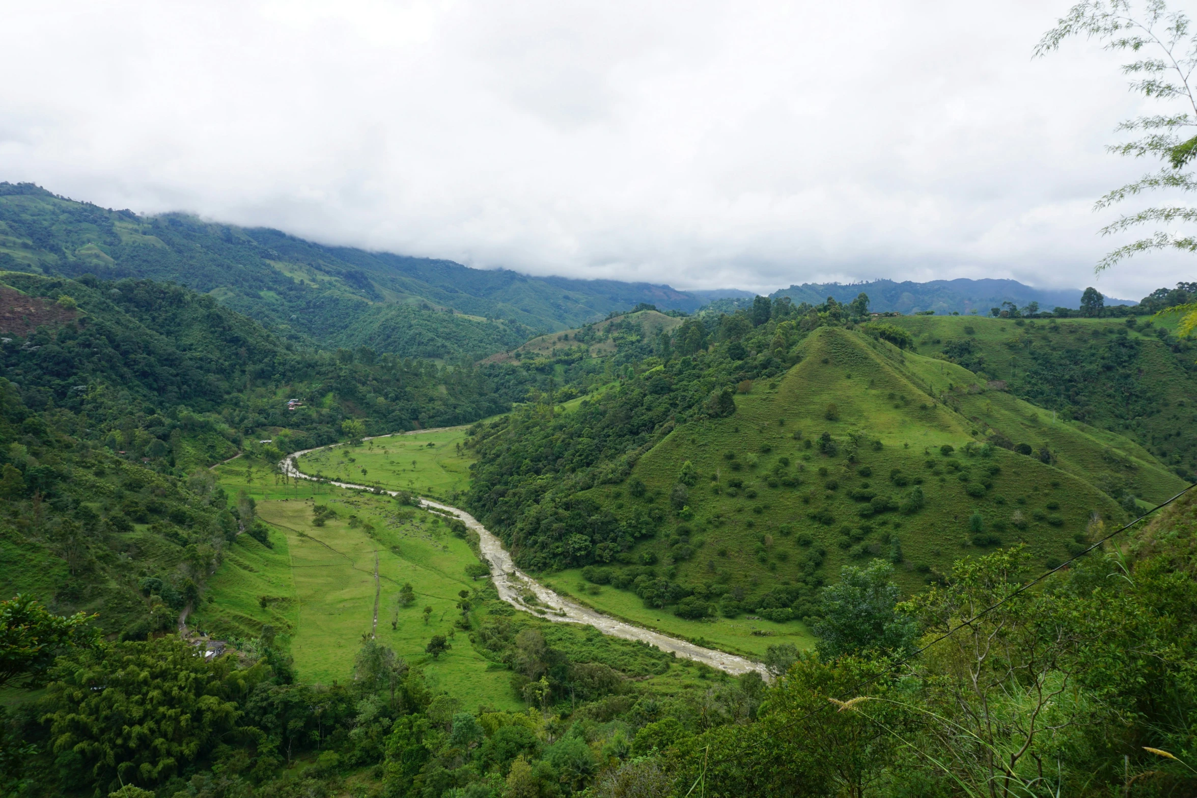 looking down a valley in the lush green hills