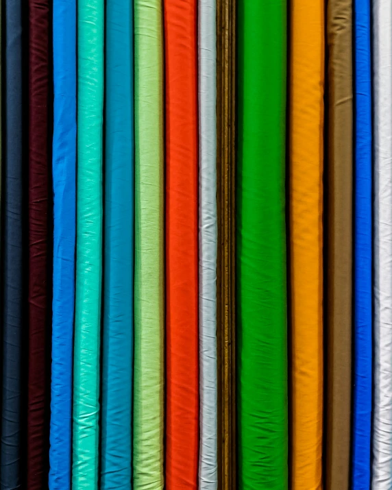 a colorful assortment of cloths stacked neatly in a row