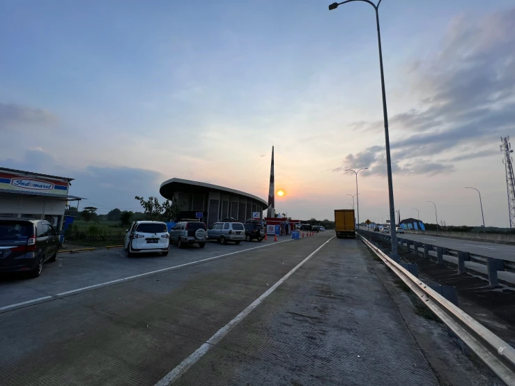 cars are sitting in line on the side of the road