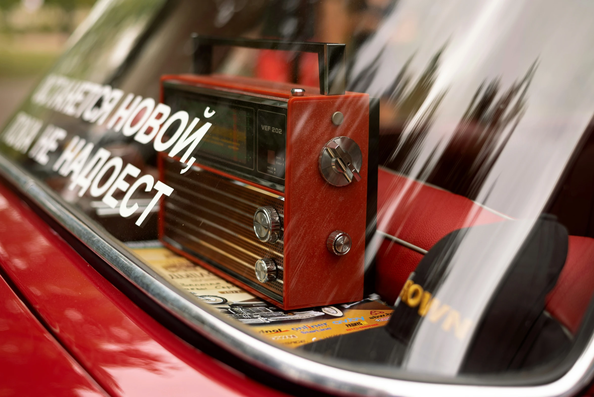 a reflection of a radio with words and an alarm clock on it