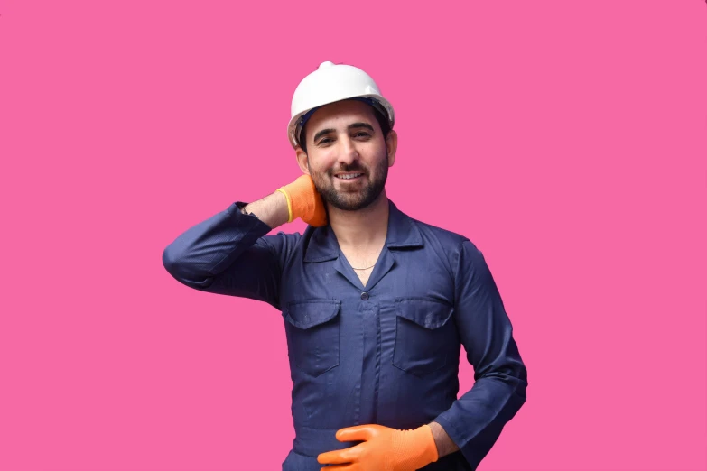 a man in blue shirt and orange gloves holding a carrot