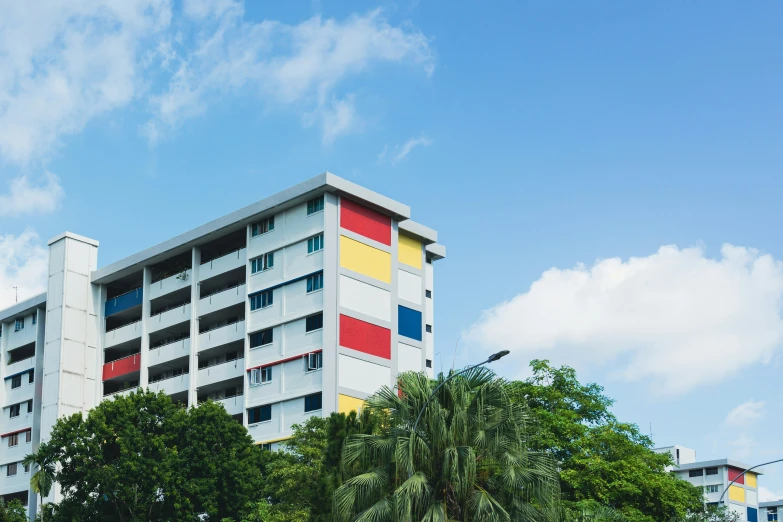 some buildings in a neighborhood with palm trees and blue sky