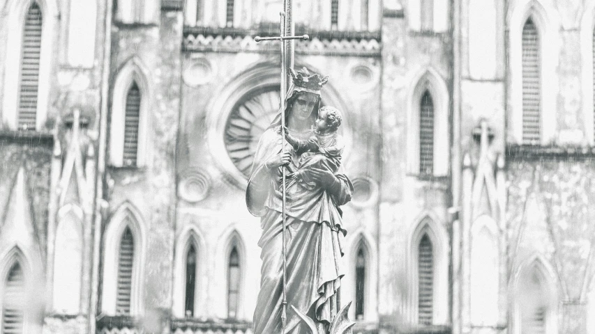 an image of the statue of mary in front of a church