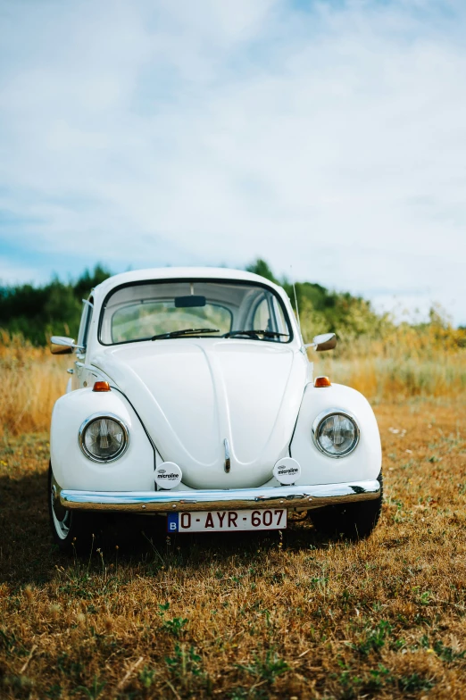 a very old car parked on some grass