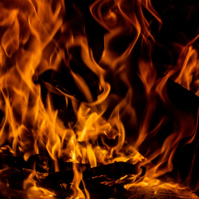 flames burning inside of a fireplace with red smoke