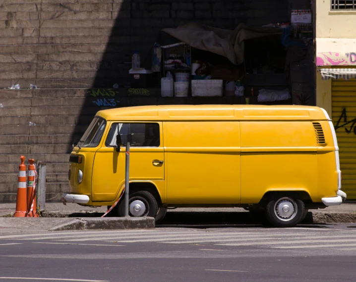 an orange van sits on the side of a road