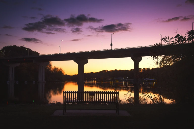 there is a bench with a railing near the water