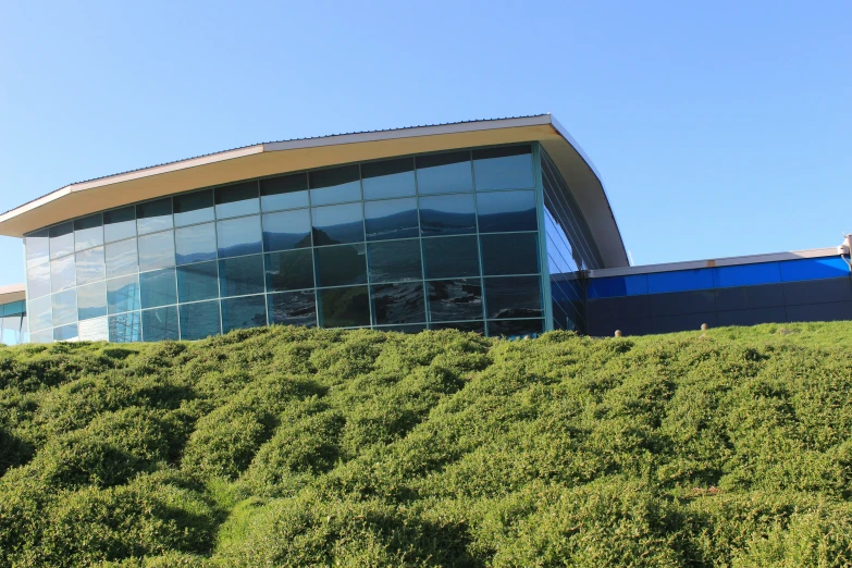 a large building on top of a green hillside