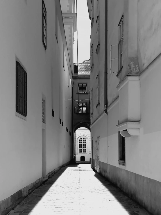 a view down an alley way looking up at the light