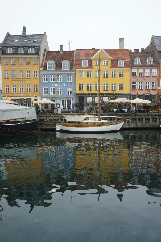 several boats on the water near some buildings